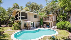 A two-story house with a swimming pool, outdoor furniture, and a 'NO DIVING' sign.