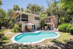A two-story house with a swimming pool, outdoor furniture, and a 'NO DIVING' sign.