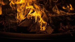 A close-up of a fire with flames consuming logs. - Coconut Grove Garden Cottage • Private Retreat with Free Parking & Full Kitchen (Miami)