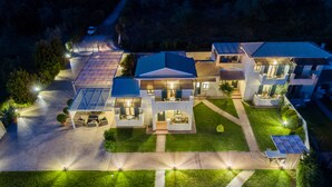 A modern residential complex with multiple houses, each featuring a patio and solar panels.
