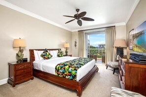 A hotel room with a large bed, two bedside tables with lamps, a ceiling fan, a balcony with a view, and a television. - Honua Kai | Ocean View 3 BR | Car Incl. w/ 6+ Nights | HKH-503 by KBM (Lahaina)