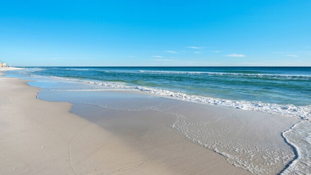 A beach with clear blue water and a sandy shore. - Seawinds 1 Beach Front Townhome (Miramar)