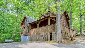 A wooden cabin with a balcony, surrounded by trees. - Whispering Oaks - Private Pigeon Forge Getaway...Close to Tanger Outlet Shopping (Sevierville)