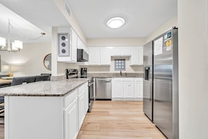 Enjoy cooking in this well-equipped kitchen with an oven, dishwasher, and refrigerator.