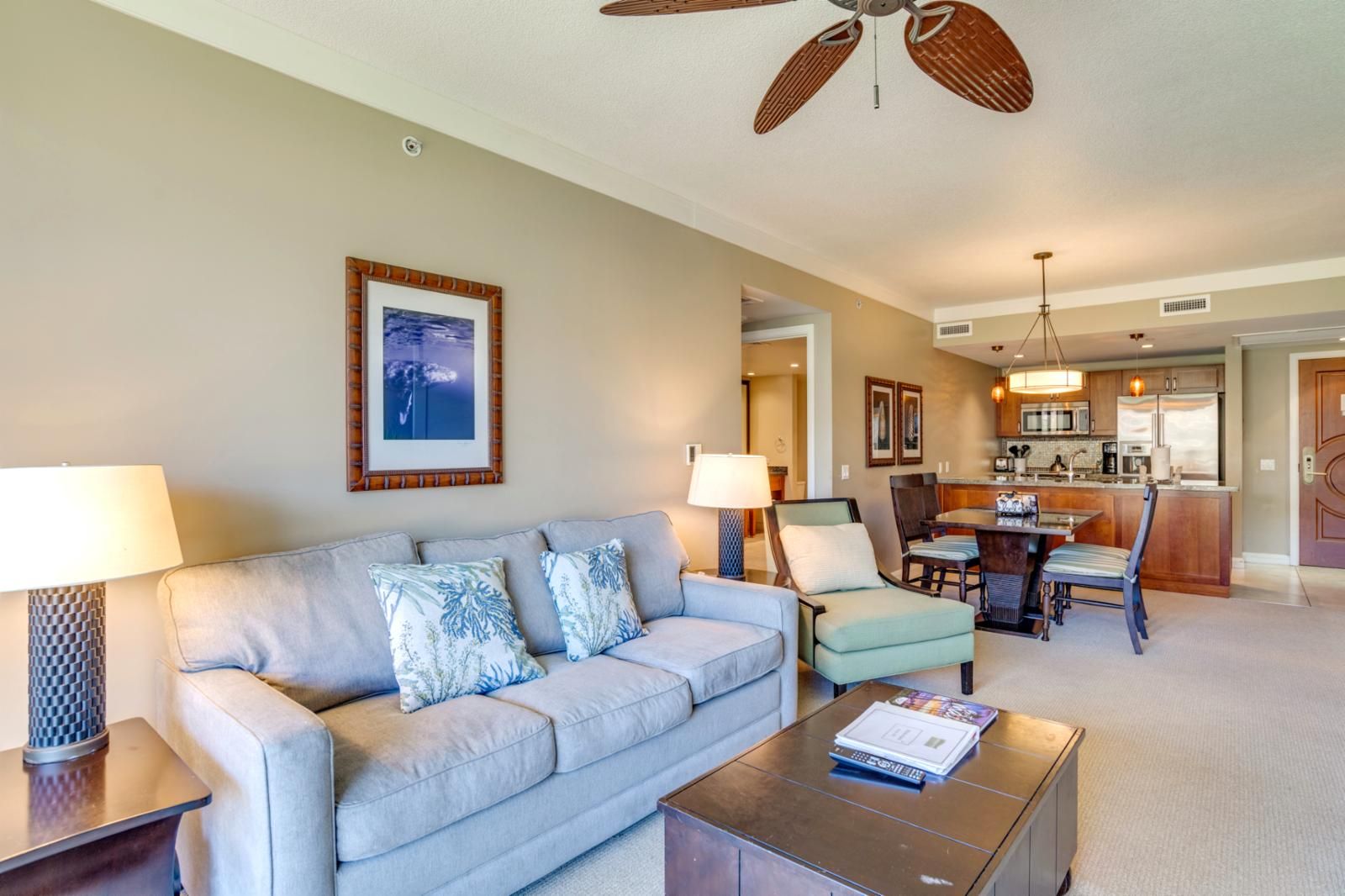 A living room with a sofa, armchairs, a coffee table, and a dining area with a table and chairs.