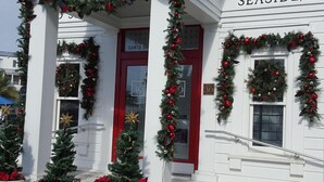 A white post office with red doors and Christmas decorations, including wreaths and poinsettias. - Reduced  rates  on 30A beach front condo. (Santa Rosa Beach)