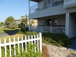 Enjoy a peaceful retreat with a balcony and seating area overlooking a beautifully manicured lawn.