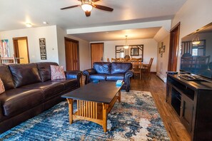 Relax in style with a comfortable sofa, coffee table, and dining area.