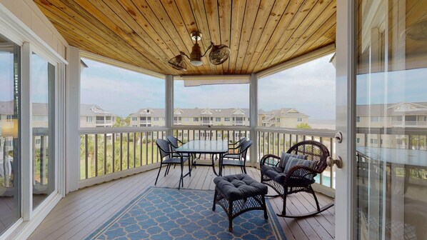 Enjoy dining and socializing in this covered outdoor space with a view of the surrounding neighborhood.