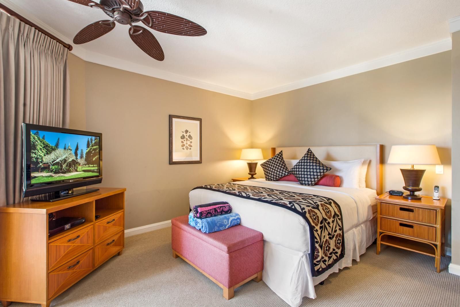 Wake up to garden views in this bright, well-appointed bedroom with TV, plush bedding, and private balcony