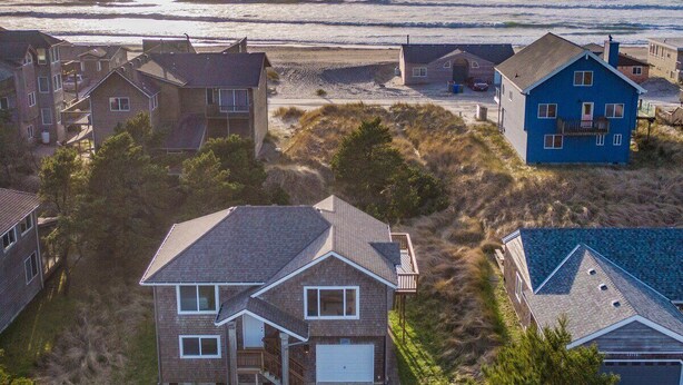 A coastal residential area with houses and a beach.