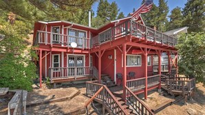 A two-story red building with a balcony and an American flag.