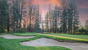 A golf course with sand bunkers and a forested background. - Modern 3-bedroom Seventh Mountain Resort Condo (Bend)