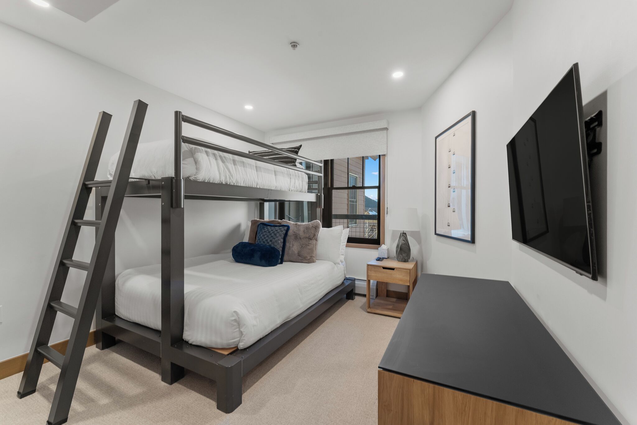 Cozy bunk room with crisp white linens and modern amenities—perfect for restful nights with your loved ones nearby.