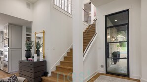 A modern interior with a staircase, a wooden floor, and a large glass door leading to an outdoor area. - PRIVATE LUXURY HOME!!!  4mi to Downtown |4 Bedrm | 3 Bath | Sleeps 8 (Austin)