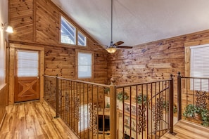 Relax in a spacious room with a central seating area, fireplace, and television.