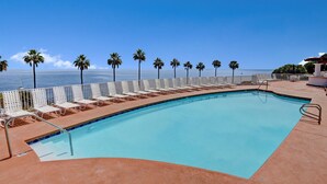 A swimming pool with a clear view of the ocean, surrounded by palm trees and lounge chairs. - 2B | 2B Villa, 6-seat cart, panoramic ocean views, AC (Avalon)