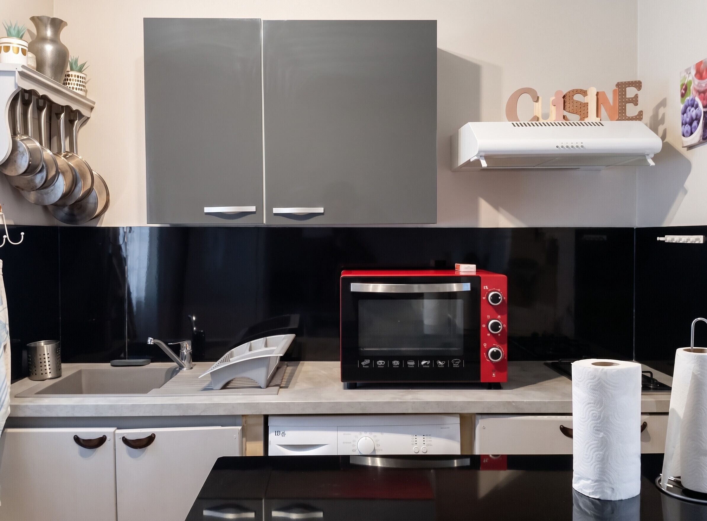 Une cuisine équipée d’un four à micro-ondes, d’un lave-vaisselle et d’un évier.