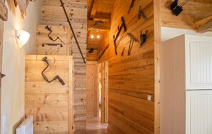 A wooden interior with a hallway leading to a room with a white door. - Homerez - Apartment Hauteluce, mountain view (Hauteluce)