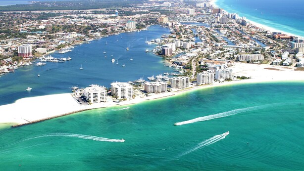 An aerial view of a coastal city with a marina, beachfront hotels, and a clear blue sea. - Blue Surf 12A- 1bd townhome with community pool! (Miramar Beach)