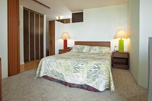 Relax in this serene bedroom with a large bed, two bedside tables, and a spacious wardrobe.