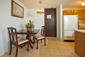 Enjoy meals at the dining table for two, accompanied by comfortable seating and a fully equipped kitchen.
