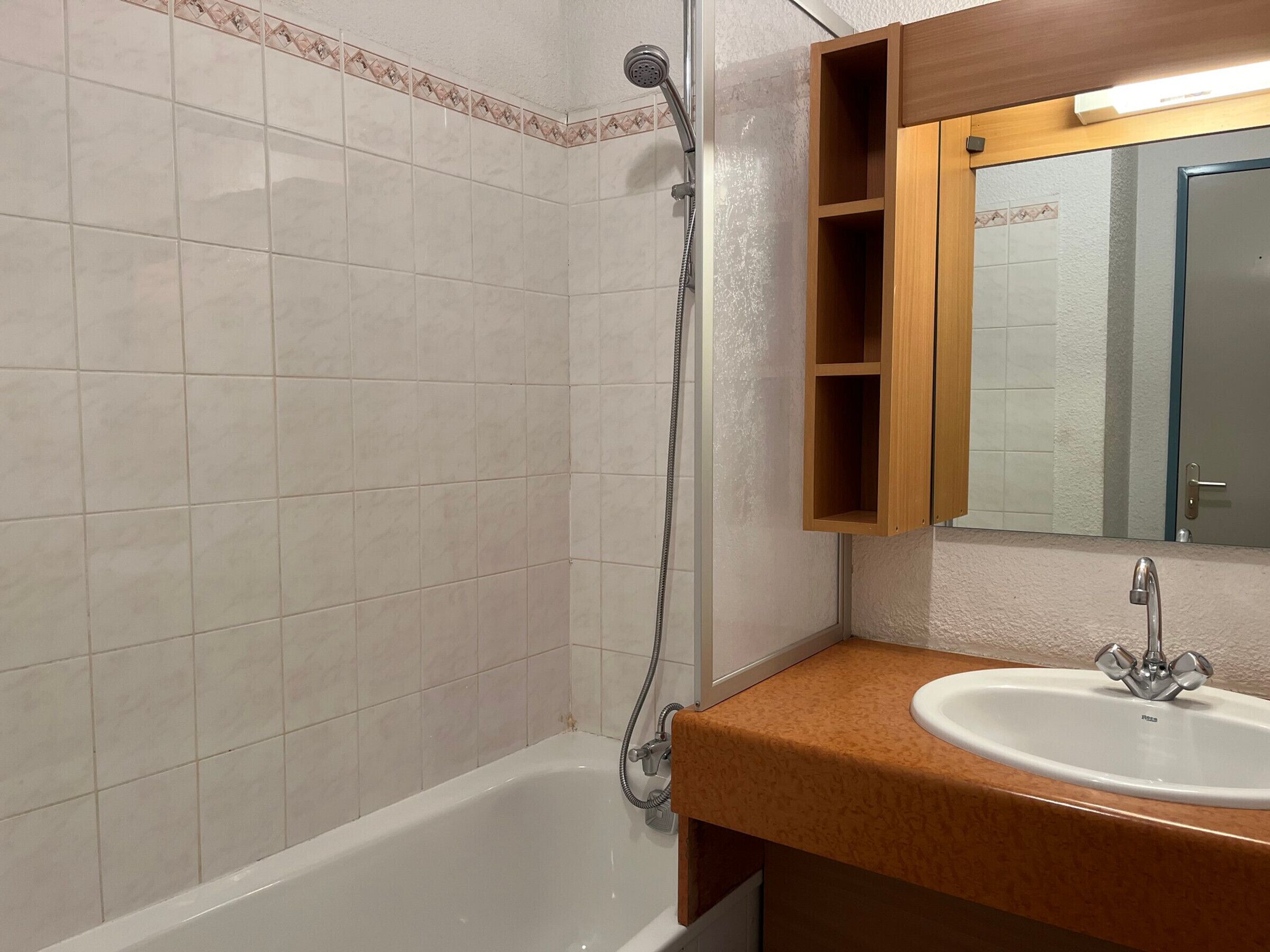 A bathroom with a bathtub, a sink, and a shower.