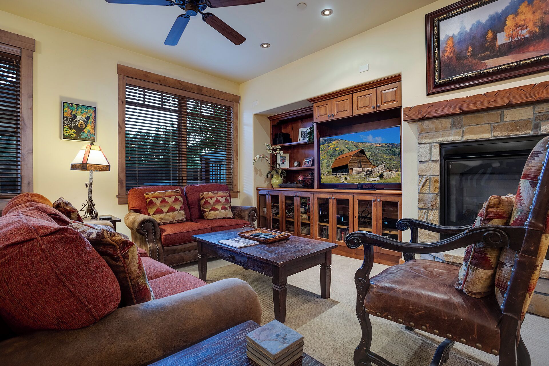 A cozy living room with a fireplace, a television, and a comfortable seating area.