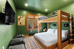 A bunk bed room with a window, a wall clock, and a small table. - Fully Remodeled Townhome - Walk to Slopes, Pool, & Hot Tub! (Keystone)