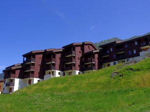 Situated on a hillside, this building offers panoramic views of the surrounding landscape from its balconies.