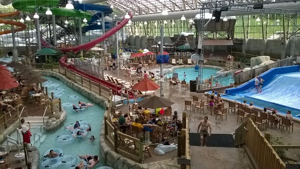 An indoor water park with multiple pools, slides, and seating areas. - Ski in/out 4 BR townhome directly on Raccoon Run and the Village Chair Lift !! (Jay)