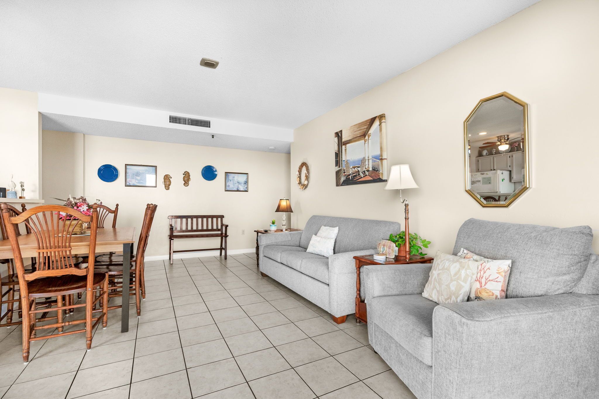 A living room with a dining table, two sofas, and a coffee table.
