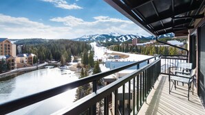 A balcony with a view of a river, mountains, and buildings. - Luxury Ski-In Penthouse- Walk to Main St (Breckenridge)