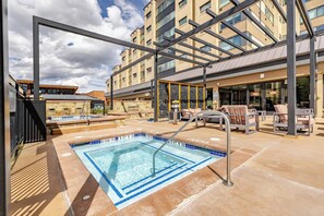 A rooftop pool area with a diving board, lounge chairs, and a building with multiple floors in the background. - Ski-In/Ski-Out Penthouse | 3BR, Sleeps 10 | Main St | Pool & Hot Tubs (Breckenridge)