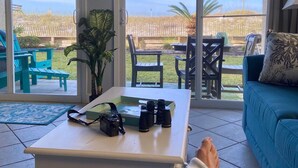 A room with a sliding glass door leading to an outdoor patio area. - Island Sands 109 -Beachfront Beauty- Corner Unit- Just WOW! (Fort Walton Beach)