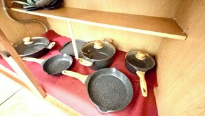 Un estante en la cocina con diversos utensilios de cocina.
