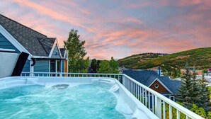 A hot tub on a balcony with a view of a hilly landscape and houses. - Abode on Woodside, private hot tub, walk to historic Main Street & trails (Park City)