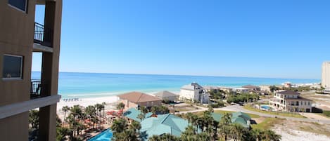 A resort with a pool, beach, and ocean view.