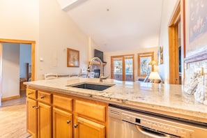Enjoy cooking in this well-equipped kitchen with a large island, sink, and ample countertop space.