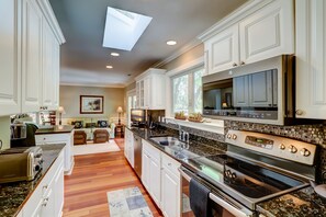 Enjoy cooking and socializing in this well-equipped kitchen with a central island, ample counter space, and appliances.