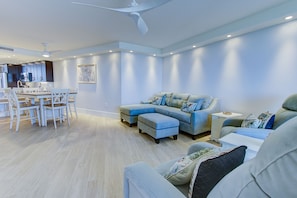 Relax in this spacious living area with a large sectional sofa and dining space.