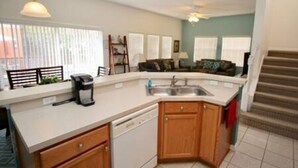 A compact kitchen with a dishwasher, a coffee maker, and a sink. - Perfect vacation Gated Resort with Private Pool (Kissimmee)