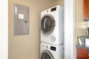 Compact laundry nook with stacked Bosch washer and dryer units.