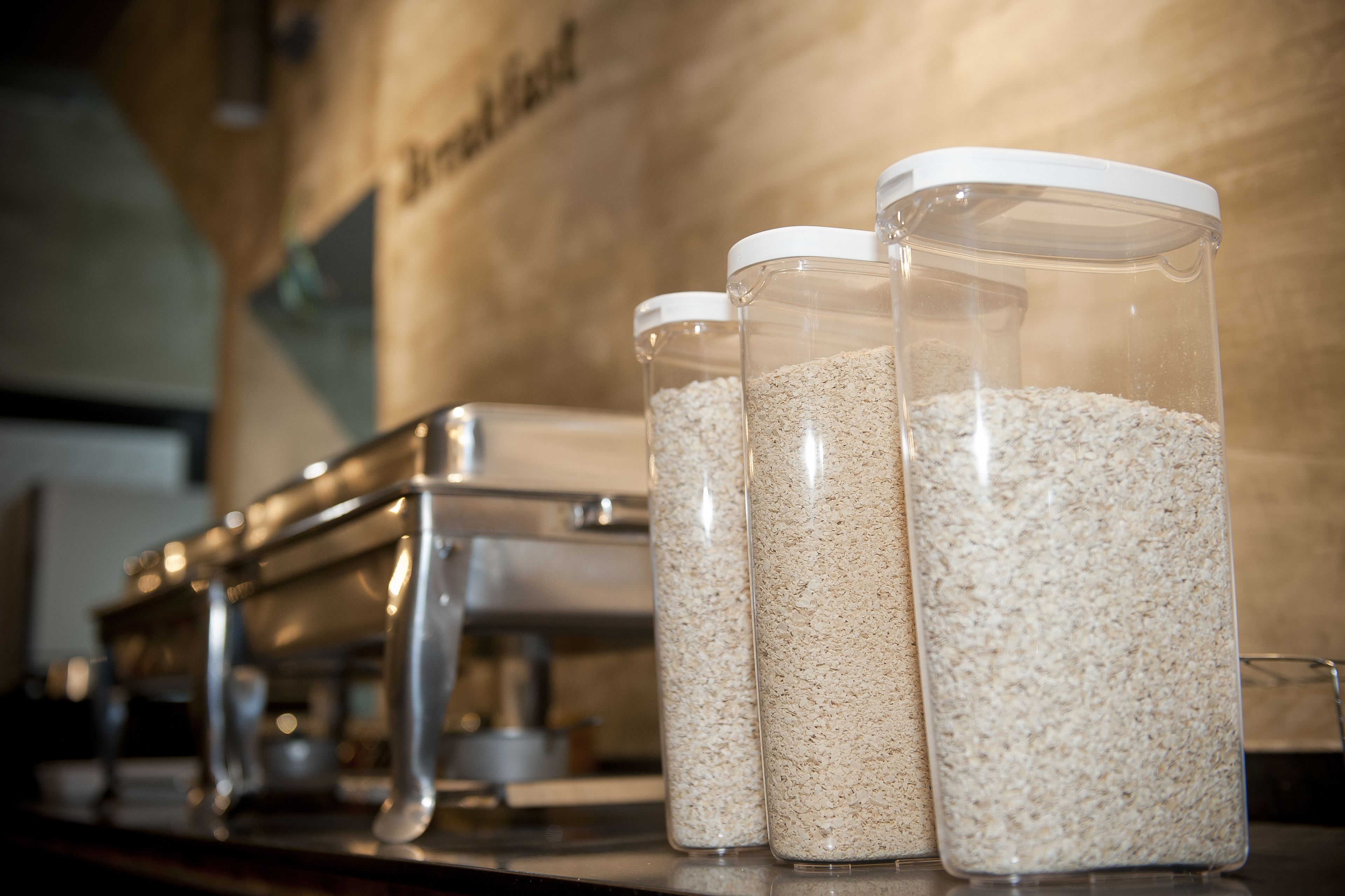 Three glass containers with lids on a countertop.