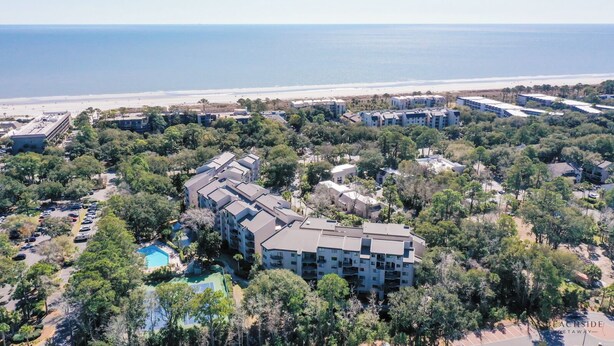 An aerial view of a resort with multiple buildings, a parking area, and a swimming pool. - 123 Forest Beach Villas (Hilton Head Island)
