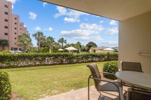 Enjoy a serene view of the lush lawn and palm trees from your balcony.