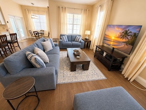 A living room with a sofa, coffee table, and TV.