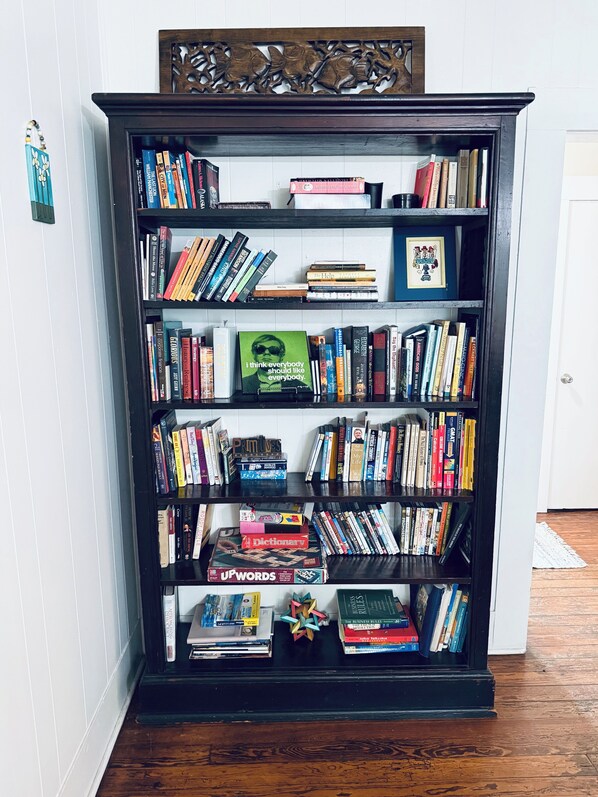 A bookshelf filled with various books and a few decorative items.