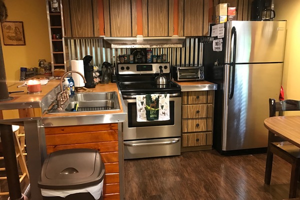 The full kitchen including a new oven, stove, and refrigerator!