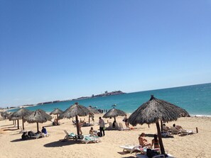 On the beach, sun-loungers, beach towels